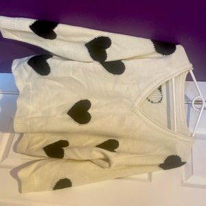 Large cream colored sweater with black hearts
